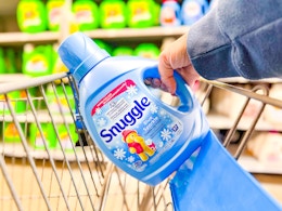 hand pulling the Snuggle fabric softener out of a Walmart cart
