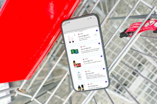 smartphone in a shopping cart displaying 1-clip coupons in the kcl app