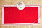 Lifestyle image of the Better Homes & Gardens Resort Style Beach Towel in red