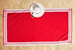 Lifestyle image of the Better Homes & Gardens Resort Style Beach Towel in red