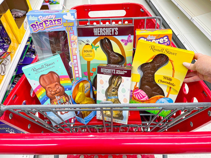 a target cart with the top basket filled with different types of chocolate easter bunnies