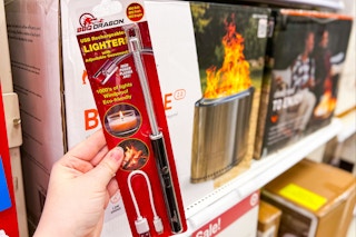 hand holding up a packed lighter in the fire pit aisle