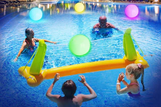 a family playing with light up beach balls
