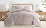 a comforter set on a bed in a room