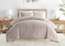 a comforter set on a bed in a room