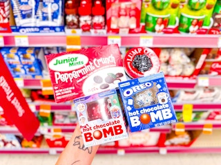 hand holding junior mints, lump of coal, hot chocolate bombs