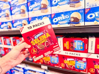 hand holding a box of selena oreos in walmart aisle