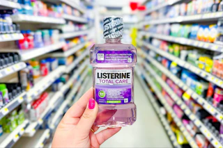 hand holding a bottle of listerine mouthwash