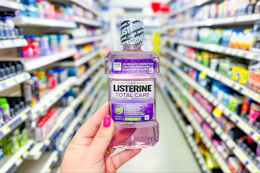 hand holding a bottle of listerine mouthwash