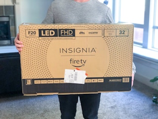 person holding insignia fire tv