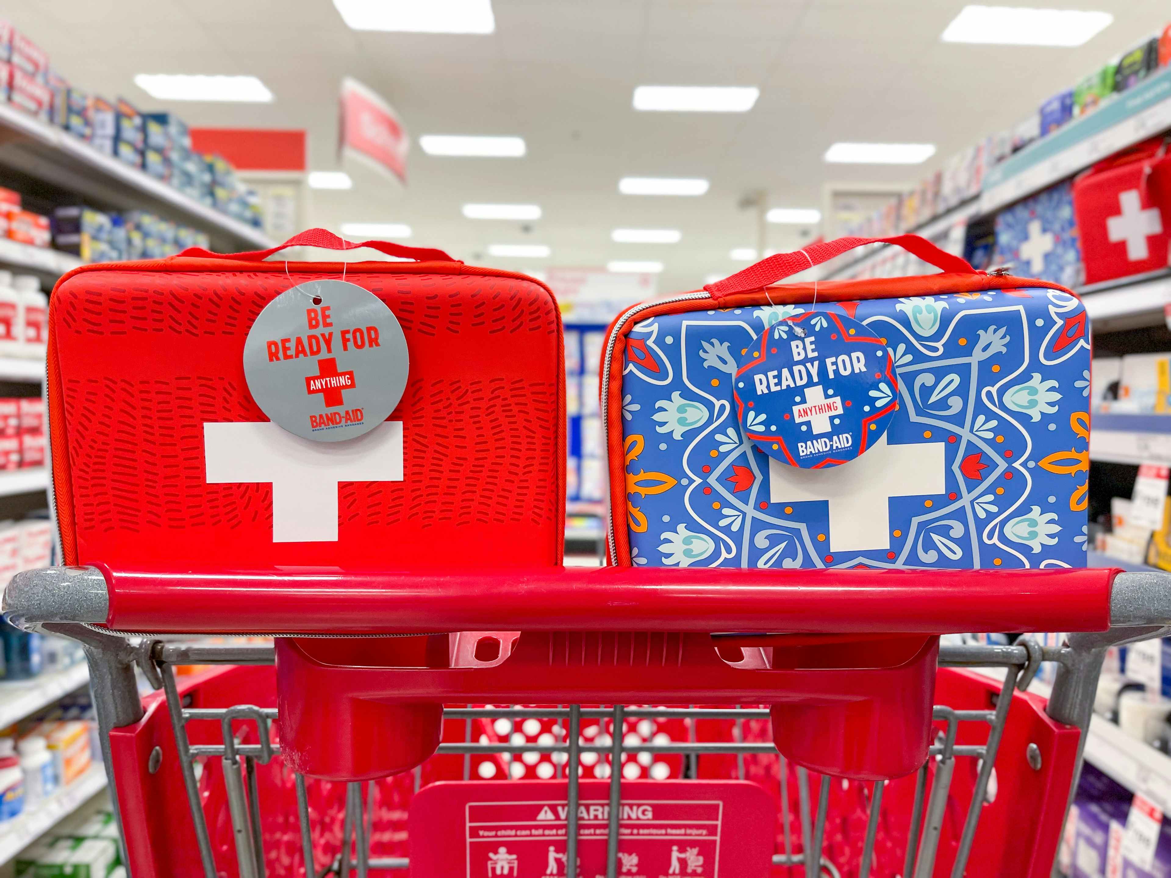 Red and blue first aid kits in a red target cart