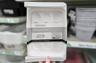 hand holding an egg holder shelf