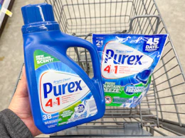 hand holding purex detergent and pacs in walgreens cart