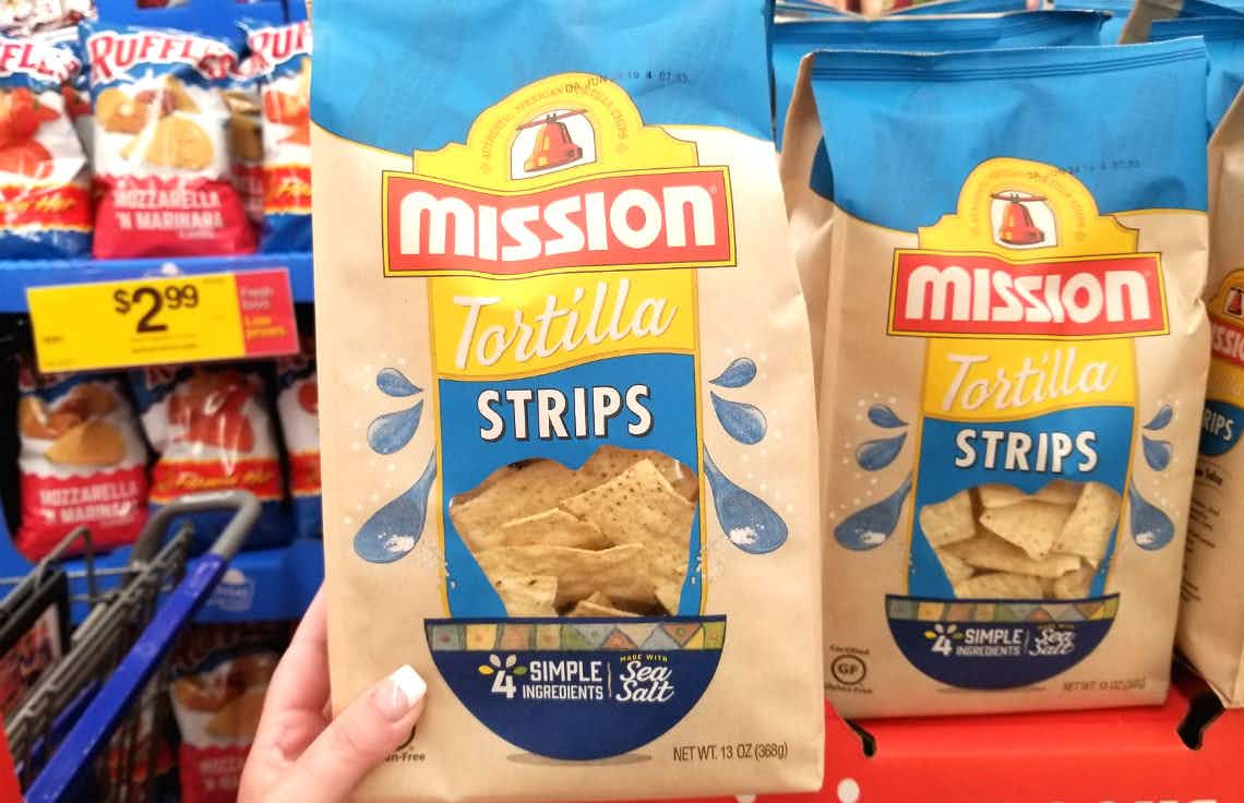 hand holding mission tortilla chips