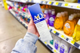 hand holding a+d treat and heal diaper rash ointment