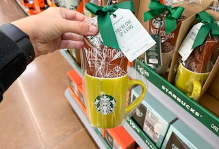 hand holding starbucks mug gift set with hot cocoa mix at walmart
