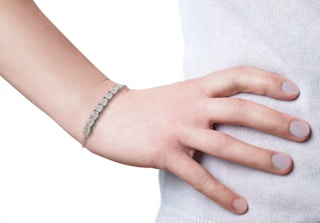 a woman wearing a diamond bracelet