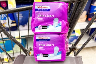 stacked packs of walgreens-brand liners in shopping cart