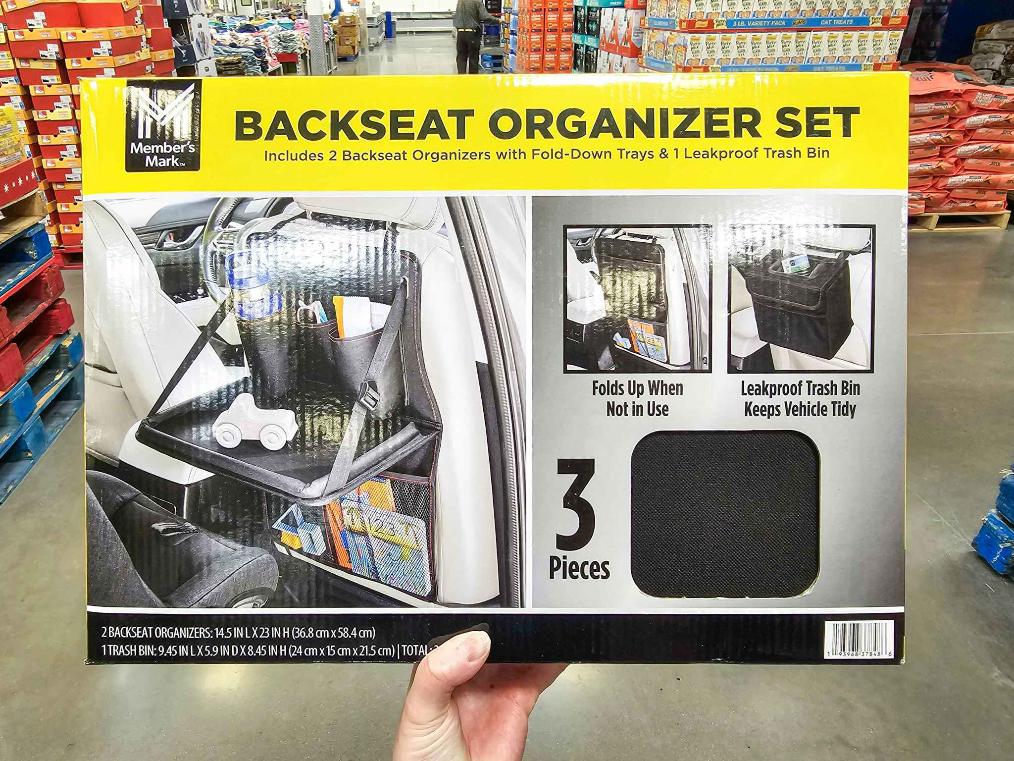 person holding a backseat organizer set