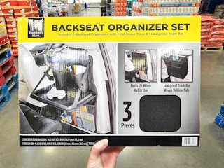 person holding a backseat organizer set