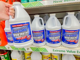 a person holding up bleach in a dollar tree