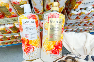 hand holding bottles of pantene botanicals hair care