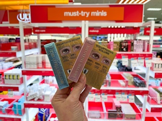 hand holding 2 too faced better than sex mascara at ulta in target