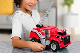a boy playing with a cat construction fire toy
