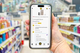 hand holding smartphone with kcl 1-clip coupon deal