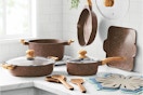 The Pioneer Woman Prairie Signature 14-Piece Cast Aluminum Cookware Set on a kitchen counter