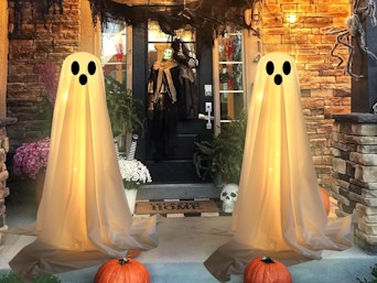 two ghost decorations outside a front door