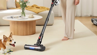 a person using a cordless vacuum 