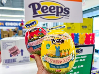 Peeps construction set at Five Below in store with someone holding a bunny and chicken set in hand in front of the Peeps branded sign