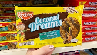 Someone holding up a package of Keebler Coconut Dreams cookies in a store