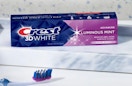 a box of toothpaste next to a toothbrush