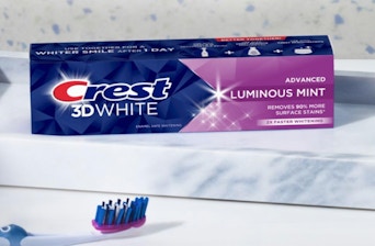 a box of toothpaste next to a toothbrush