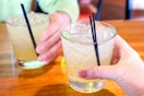 two hands holding up a margarita