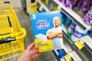hand holding a box of mr. clean magic erasers