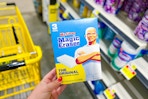hand holding a box of mr. clean magic erasers