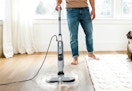 person using the Shark Steam and Scrub Mop on hardwood floors