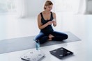 woman sitting on floor near scale