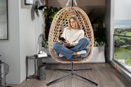 Lifestyle image of the Bifanuo Egg Chair with Stand (woman using it to read a book)