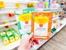 person holding 2 burts bees sheet masks