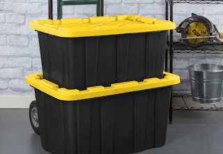 black totes with yellow lids on a dolly