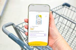 hand holding a smartphone displaying a 1-clip coupon in the kcl app
