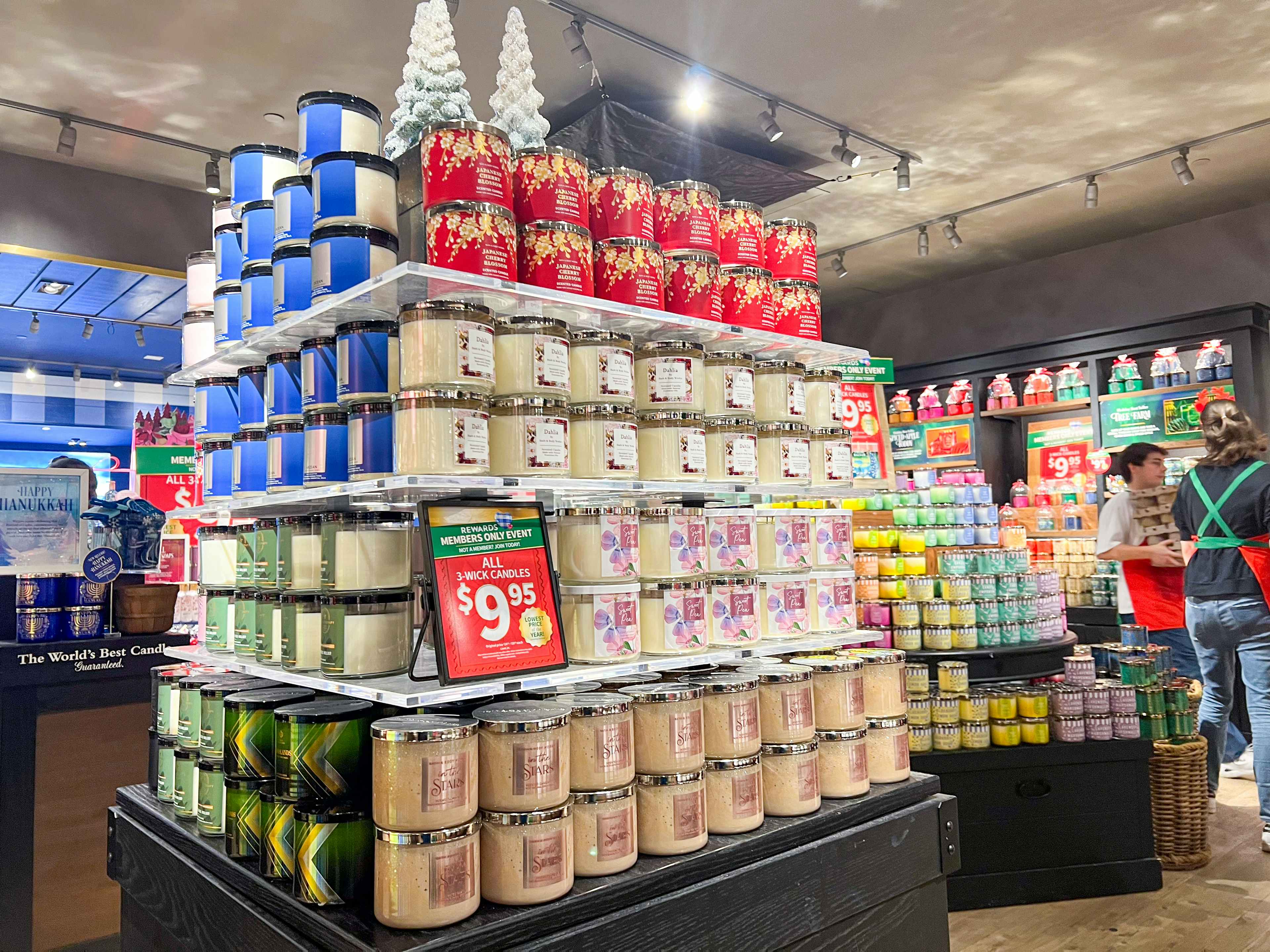 Large display of candles during the candle day sale at Bath and Body works . Small red sign showing the offer of $9.995