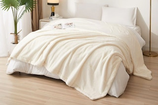 Lifestyle image of the Mainstays Faux Fur Blanket (king size) in the color "Vanilla Dream"