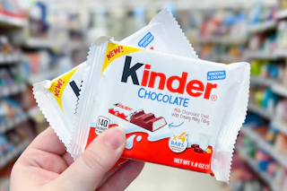 2 Kinder Chocolate Bars held up center aisle at Walgreens (zoomed in to make it appear like Walmart)