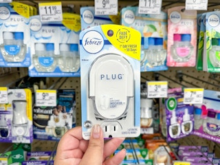 hand holding febreze plug in at walgreens