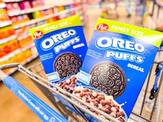 two boxes of Oreo Puffs cereal in a Walmart cart